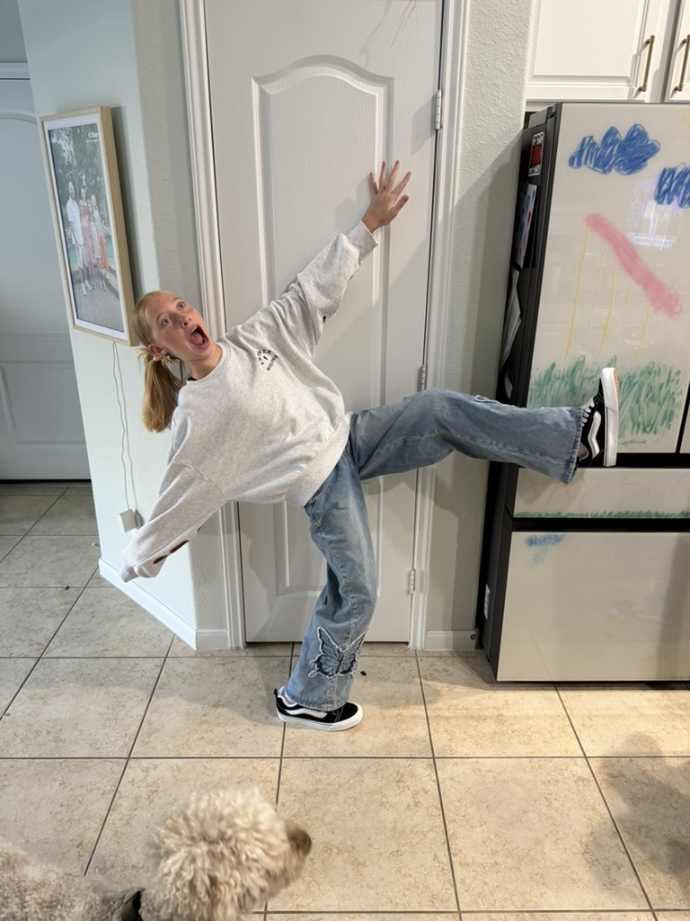 Silly kick pose in the kitchen